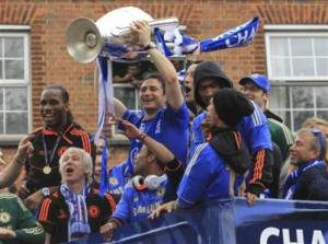 Chelsea's Frank Lampard holds the Champions League trophy near owner Roman Abramovich during their victory parade in west London